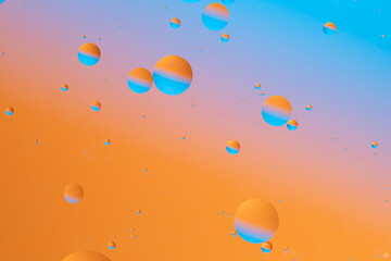 Bright orange and blue circular shapes in a gradient.