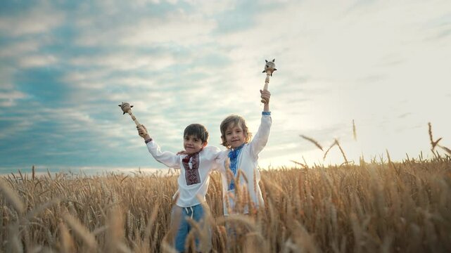 Little ukrainian children boys with Maces - bludgeon in field. Bulava, Ukraine.