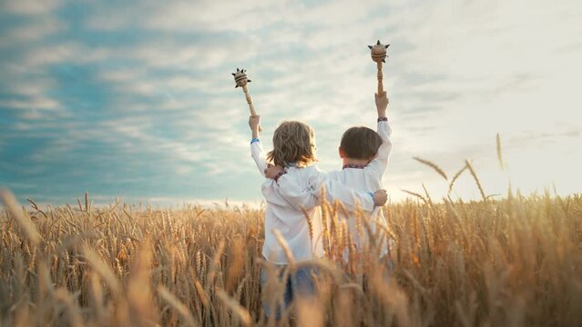 Little ukrainian children boys with Maces - bludgeon in field. Bulava, Ukraine.