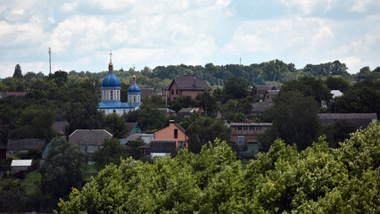 church. view of the Ukrainian church in the village. religion, Christianity. church holidays. crosses on the domes. no people. roofs of houses. summer or spring time. Orthodox temple.