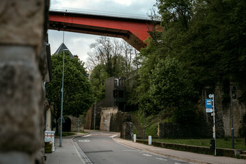 Grund quarter of Old Town in Luxembourg with red Grand Duchess Charlotte Bridge in the background. Pfaffenthal district in Luxembourg the capital of Grand Duchy of Luxembourg