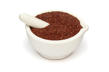 Close-up of Dry Organic Sleeping plant or Lajvanti (Mimosa pudica) seeds, in white ceramic mortar and pestle, isolated on a white background.