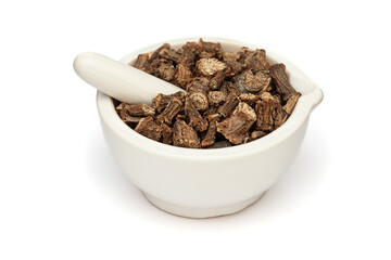 Close-up of Dry Organic Gulvel or Giloy (Tinospora cordifolia) herb, in white ceramic mortar and...