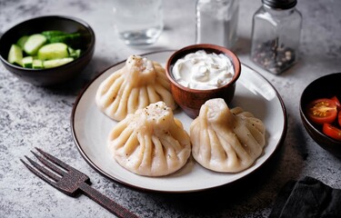 Khinkali with cream sauce in a plate