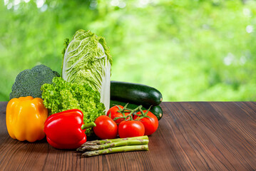 Fresh ripe vegetables on a wooden table, free space.