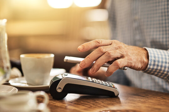 Hand, smartphone and pos terminal in restaurant for payment, purchase and fintech with mobile app. Cafe, senior customer and cellphone by machine for tap, nfc and digital transaction for service