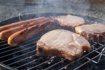 juicy delicious meat steaks and sausages fried on barbecue