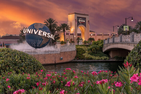 Orlando, Florida, USA. July 13th 2023 Universal Studios Theme Park Orlando, Universal globe and entrance at sunset. Bright colourful sky and lighting