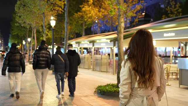 Paris, France. The Champs-Elysees street in the evening and a girl walking 