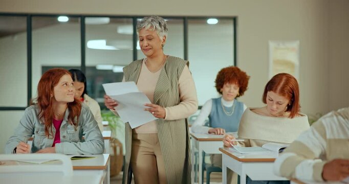 Woman, teacher and handing paper in classroom for test, diverse students with pen for education. Female person, walking or hands with document for exam in high school, teenager learning for knowledge