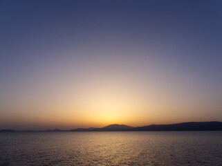 Idyllic sunset over aegean sea. View from Hydra island, Saronic Gulf. Greece. 