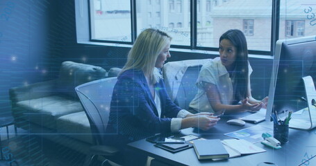 Image of data processing and light trails against two diverse women discussing at office