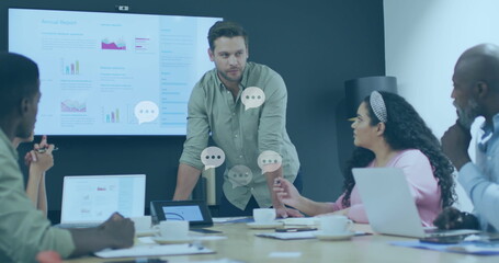 Image of message icons floating against caucasian man talking to diverse colleagues at office