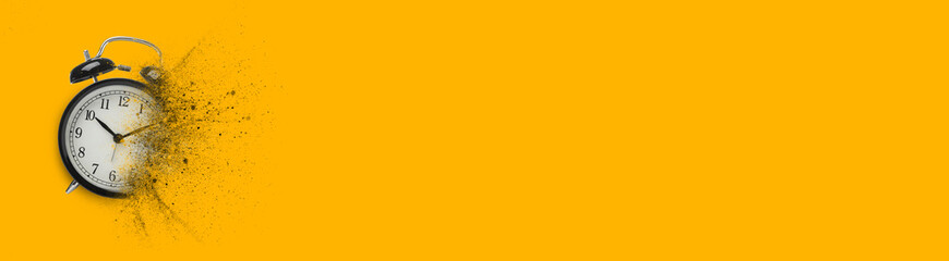 Black alarm clock dissolving on orange background, banner design with space for text. Flow of time