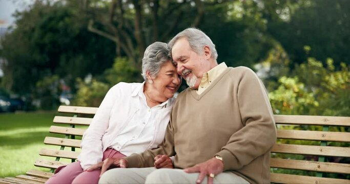 Senior couple, park and smile in bench for bonding, love and retirement in New York. Relationship, people and happy hug with forehead touch as pensioner for mindfulness, trust and support outdoor