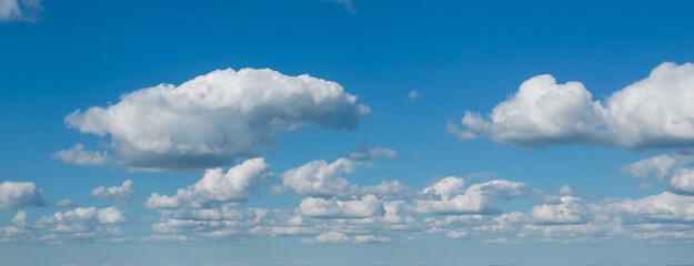 Poofy Clouds in a blue sky