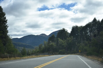 Street in the forest with mountains