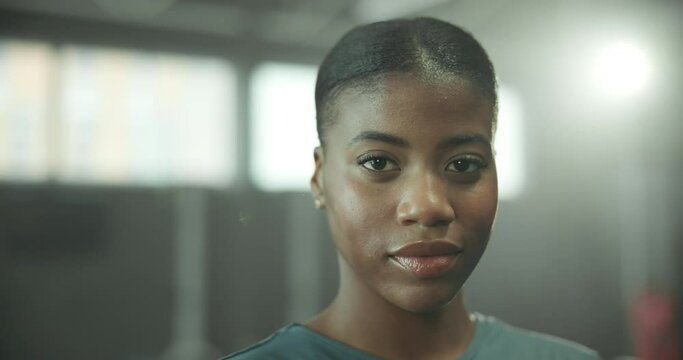 Face, fitness and serious with woman in gym for start of exercise, training or workout routine. Challenge, confident and portrait of African person in health club for improvement or performance