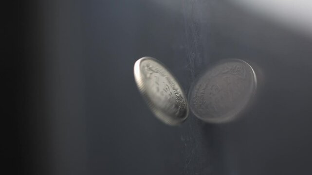 One Swiss Franc coin rotating slow motion, 1 CHF, vertical view