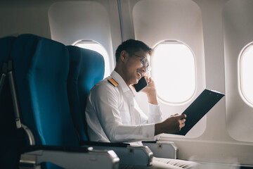 .Portrait of a trained airplane captain in uniform preparing to fly in a simulator cockpit.