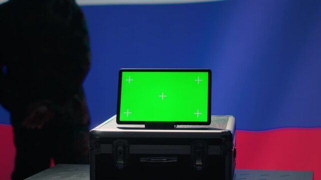 ex KGB FSB secret police agent using mass propaganda tools on green screen laptop to influence population minds. Russian spy silencing online opposition voices using mockup notebook, camera A