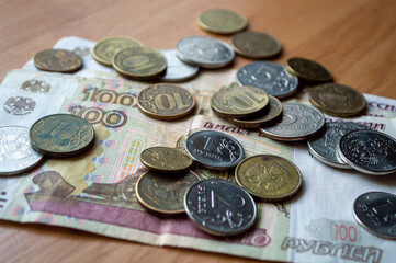 Russian currency, coins, banknotes lie on a wooden surface