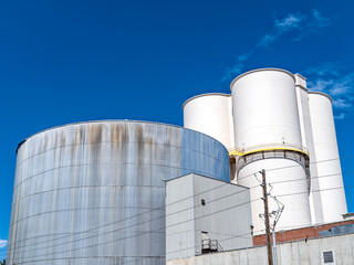 The tops of industrial storage tanks at a food processing facility