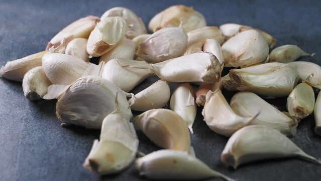 close up pf garlic dropping on a table 