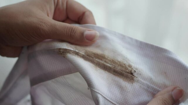 A closeup view of a grimy white shirt with a soiled collar, requiring cleaning