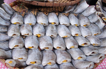Many sun dried snake skin gourami fish (Trichogaster pectoralis) in bamboo wood tray for sale in...