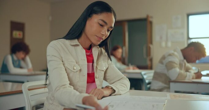 High school, girl and writing in exam for scholarship, thinking and ideas in classroom, students or education. Female person, teenager and remember in learning, development with confident in academy