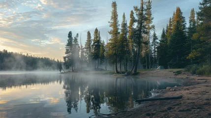 A serene campsite on the shore of a tranquil lake, with tall trees reflected in the calm water and mist rising in the morning light.