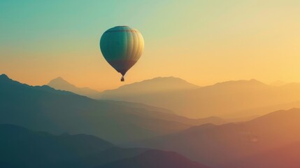 Fototapeta premium A single hot air balloon floats peacefully over a misty mountain landscape at sunrise, capturing the essence of adventure and tranquility.