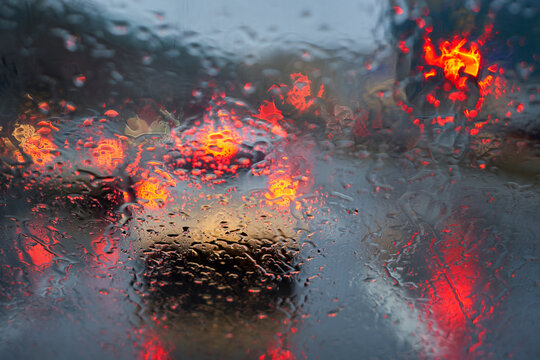 Traffic in bad weather. Windshield with raindrops.