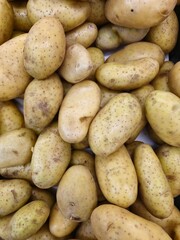 Close-up view of a heap of fresh, raw potatoes at a market stall