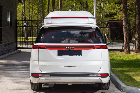 Novosibirsk, Russia -  June 01, 2024:  white Kia Carnival parked of a city. No other car and people.