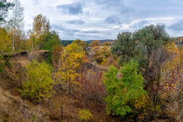 Bright autumn landscape with cloudy sky.