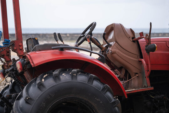 Close-up of an old red tractor - Powered by Adobe