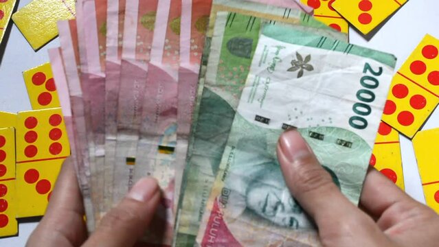Young Asian woman counting rupiah money