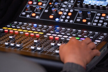 Person operating professional audio mixing console