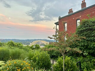 Sunset over Daniel Carter Beard Bridge, brick building in Cincinnati