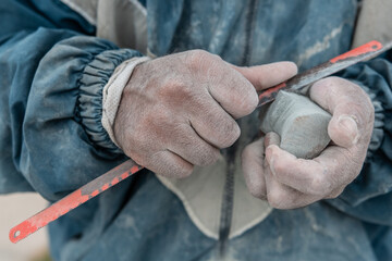 man's hands carving stone in La Paz Bolivia