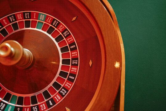 Close-up of roulette wheel on a green table