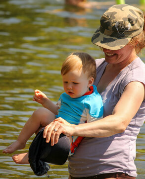 Mother and toddler playing in the water