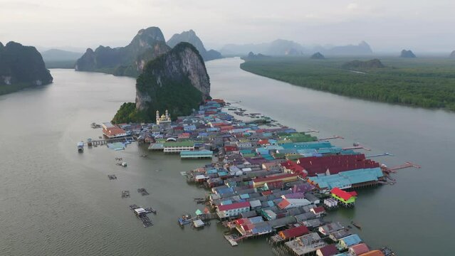 Aerial view of Koh Panyee, The Floating village urban city town houses, lake sea or river. Nature landscape fisheries and fishing tools at Pak Pha, Phang Nga, Thailand. Aquaculture farming
