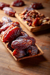 Juicy ripe dates on a wooden table.