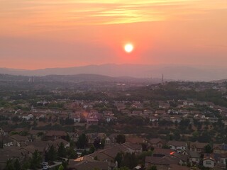 A view of the setting sun on a sky obscured by smoke and haze from the hills of San Ramon