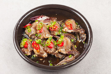  A food made by boiling ingredients such as onions and peppers, then pouring the cooled soy sauce over prepared crabs several times and allowing them to age.
