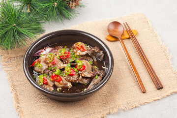  A food made by boiling ingredients such as onions and peppers, then pouring the cooled soy sauce over prepared crabs several times and allowing them to age.
