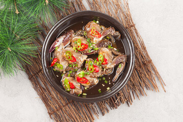  A food made by boiling ingredients such as onions and peppers, then pouring the cooled soy sauce over prepared crabs several times and allowing them to age.
